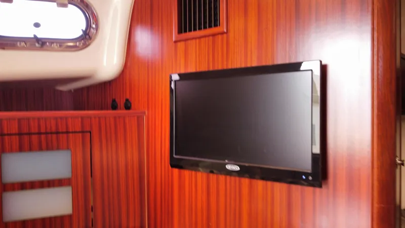 Slide: The Image of Interior of 2020 Pursuit OS 385 Offshore with wood paneling and mounted TV. - 27