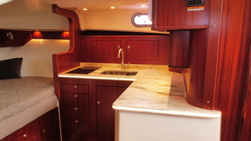 Slide: The Image of Luxurious 2020 Pursuit OS 385 Offshore yacht interior with elegant wood cabinetry and modern amenities. - 28