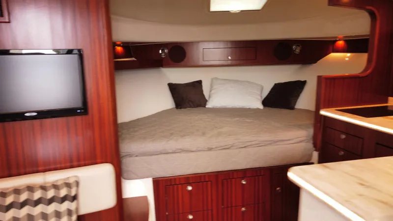 Slide: The Image of Luxurious cabin interior of 2020 Pursuit OS 385 Offshore yacht with cozy bed and TV. - 29