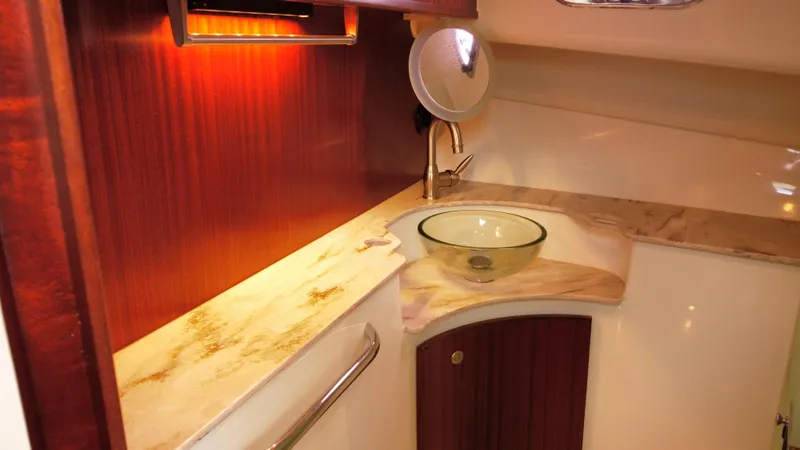 Slide: The Image of Luxurious 2020 Pursuit OS 385 Offshore yacht bathroom with elegant sink and wood accents. - 30