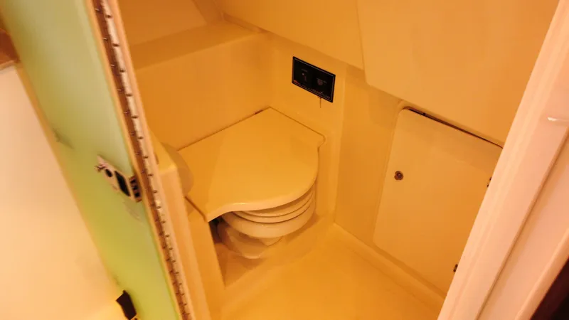 Slide: The Image of 2020 Pursuit OS 385 Offshore boat bathroom interior with compact toilet. - 31