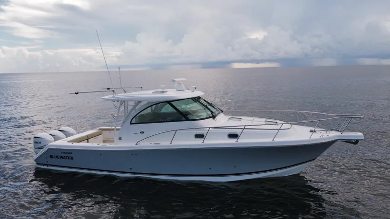 Slide: The Image of 2020 Pursuit OS 385 Offshore boat on calm ocean waters under cloudy sky. - 34