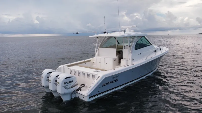 Slide: The Image of 2020 Pursuit OS 385 Offshore boat on calm water, featuring twin Yamaha engines. - 35