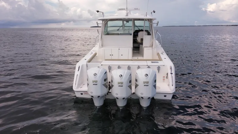 Slide: The Image of 2020 Pursuit OS 385 Offshore boat with triple engines on open water. - 36
