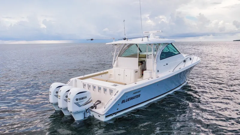 Slide: The Image of 2020 Pursuit OS 385 Offshore boat on open water, featuring twin Yamaha engines. - 4