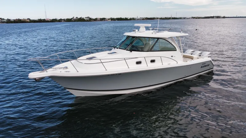 Slide: The Image of 2020 Pursuit OS 385 Offshore boat cruising on open water. - 40