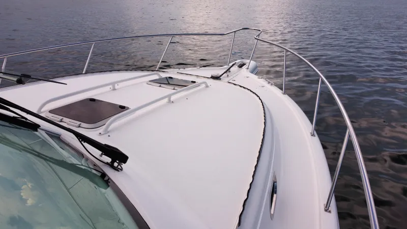 Slide: The Image of 2020 Pursuit OS 385 Offshore boat on calm water, showcasing sleek deck design. - 42