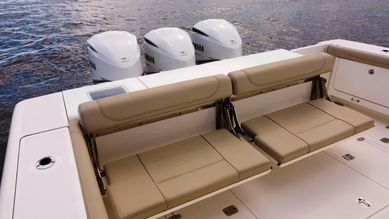 Slide: The Image of 2020 Pursuit OS 385 Offshore boat with triple Yamaha engines and tan seating. - 5