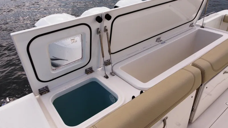 Slide: The Image of 2020 Pursuit OS 385 Offshore boat with open storage compartments and seating. - 7
