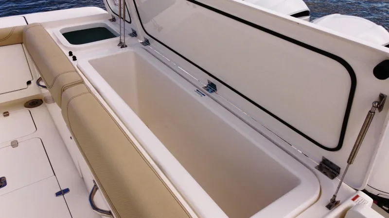 Slide: The Image of 2020 Pursuit OS 385 Offshore boat with open storage compartment. - 8