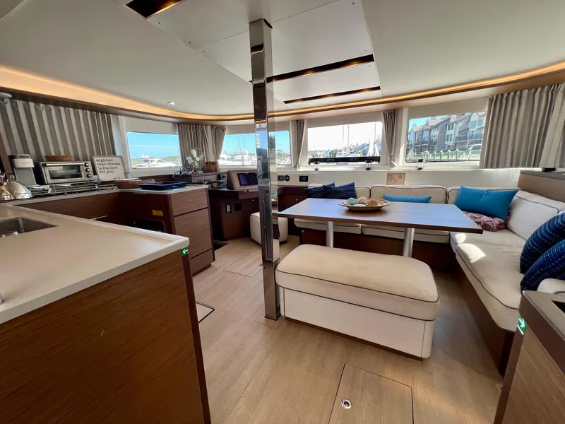 Slide: The Image of Luxurious interior of 2022 Lagoon 46 catamaran with modern seating and dining area. - 14
