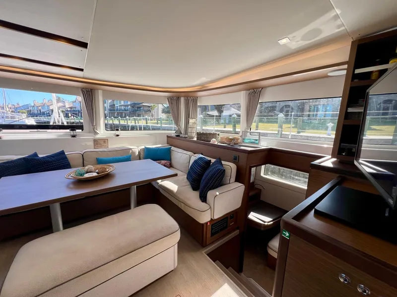 Slide: The Image of Luxurious interior of 2022 Lagoon 46 catamaran with plush seating and large windows. - 15