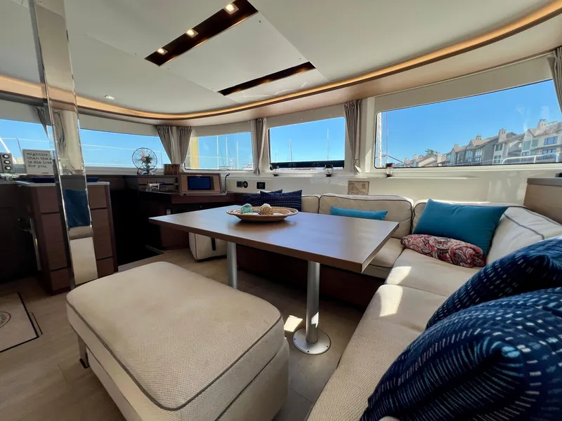 Slide: The Image of Luxurious interior of 2022 Lagoon 46 catamaran with spacious seating and panoramic windows. - 17