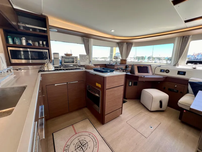 Slide: The Image of Luxurious interior of 2022 Lagoon 46 catamaran with modern kitchen and panoramic windows. - 18