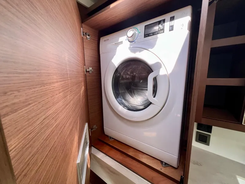 Slide: The Image of Washing machine in 2022 Lagoon 46 yacht's wooden cabinet. - 27