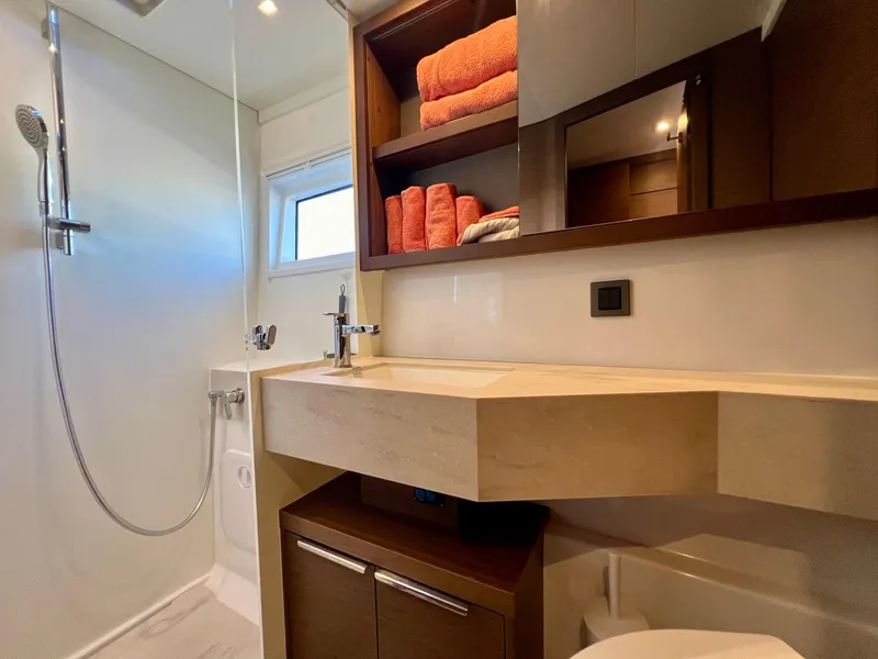 Slide: The Image of Modern bathroom in 2022 Lagoon 46 yacht with shower, sink, and storage shelves. - 34