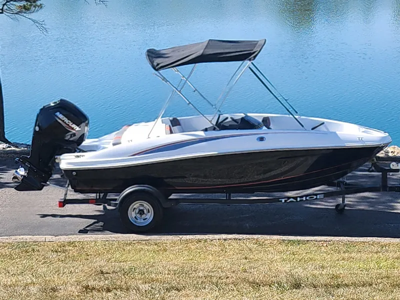 The Image of 2021 Tahoe T16 boat with canopy on trailer by a lake. - 0