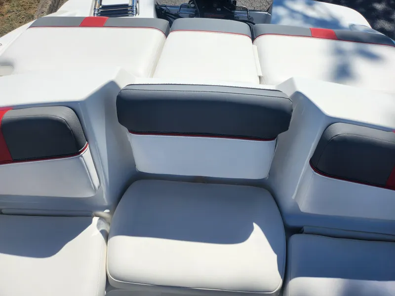 Slide: The Image of 2021 Tahoe T16 boat interior with white and gray seating, featuring red accents. - 19