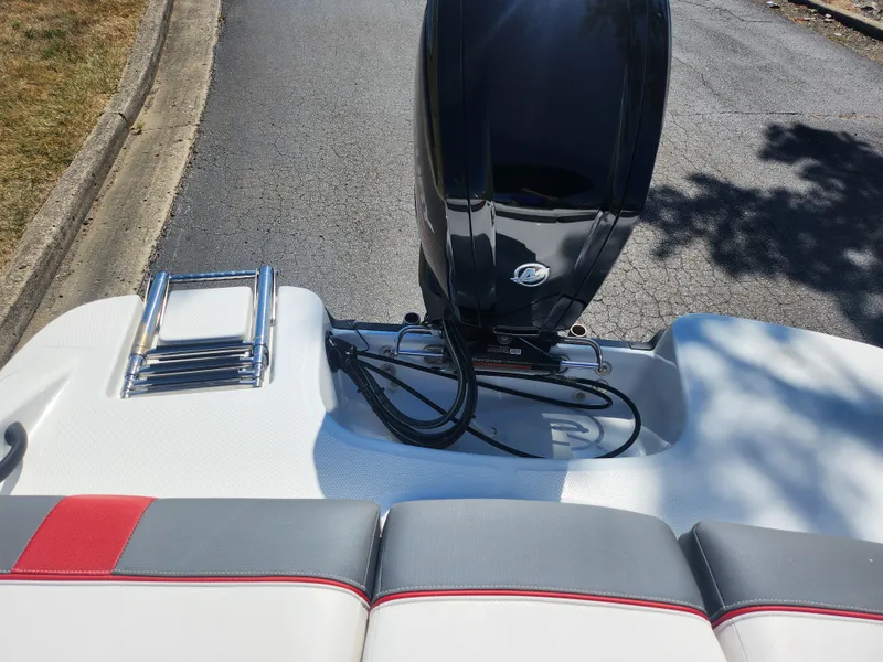 Slide: The Image of 2021 Tahoe T16 boat with outboard motor and cushioned seating, parked on a paved road. - 22