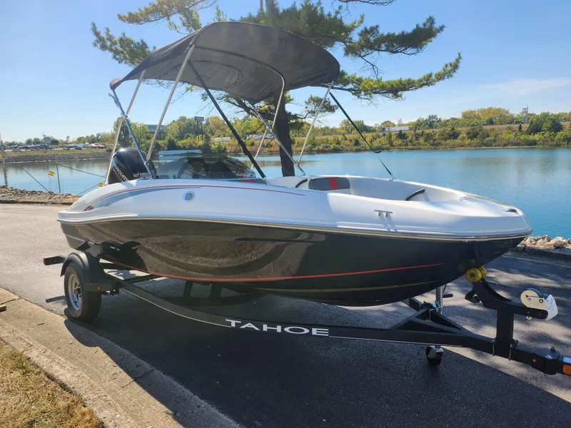 Slide: The Image of 2021 Tahoe T16 boat on trailer by a scenic lake. - 8
