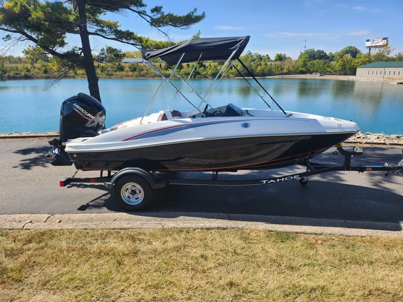 Slide: The Image of 2021 Tahoe T16 boat on trailer by a scenic lake. - 9