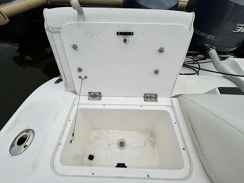 Slide: The Image of Open storage compartment on a 2003 Marlago FS35 boat, showing interior details. - 10