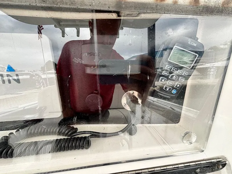 Slide: The Image of 2003 Marlago FS35 boat dashboard with radio and coiled cables. - 21