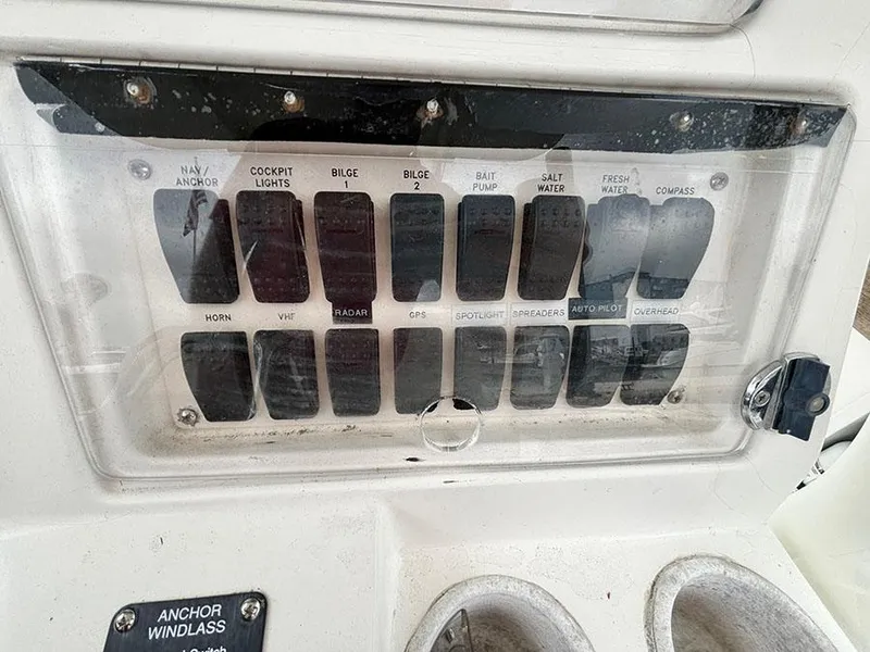 Slide: The Image of Control panel of a 2003 Marlago FS35 boat with labeled switches and buttons. - 22