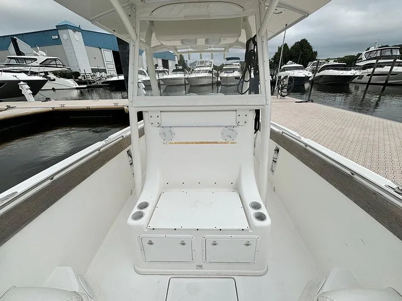 Slide: The Image of 2003 Marlago FS35 boat interior at marina, showcasing seating and storage compartments. - 29