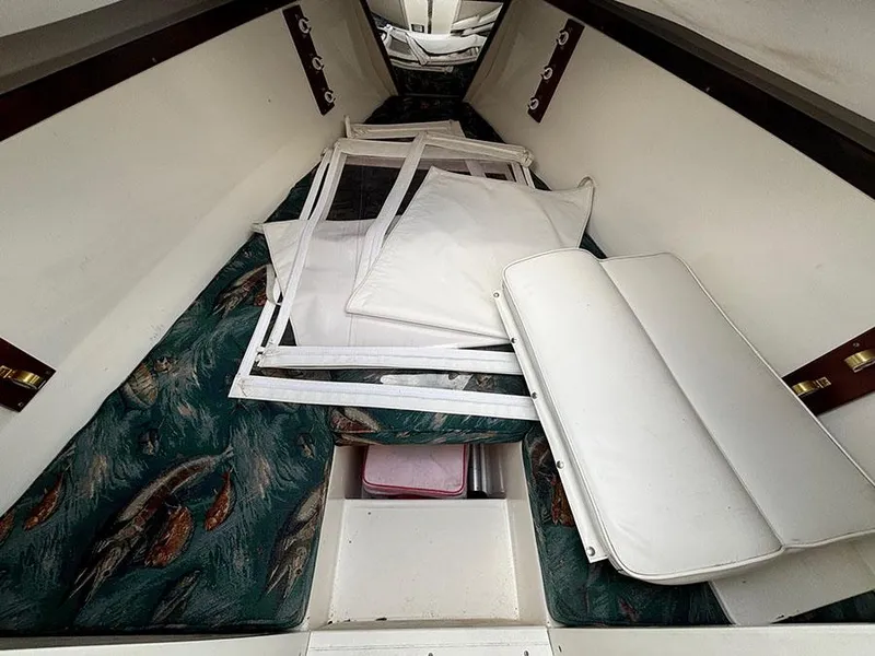 Slide: The Image of Interior cabin of a 2003 Marlago FS35 boat with cushions and storage. - 31