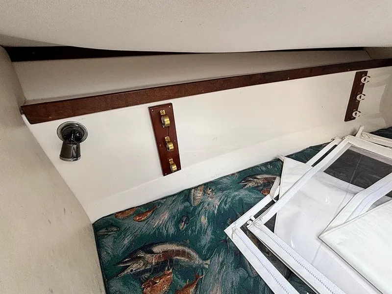 Slide: The Image of Interior of 2003 Marlago FS35 boat with fish-patterned upholstery and wooden accents. - 32