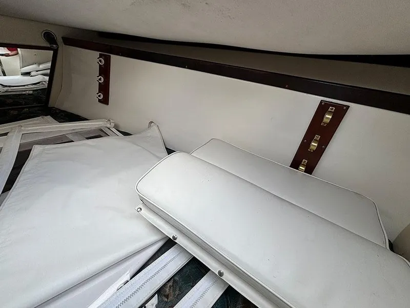 Slide: The Image of Interior of a 2003 Marlago FS35 boat with white cushions and wooden accents. - 33