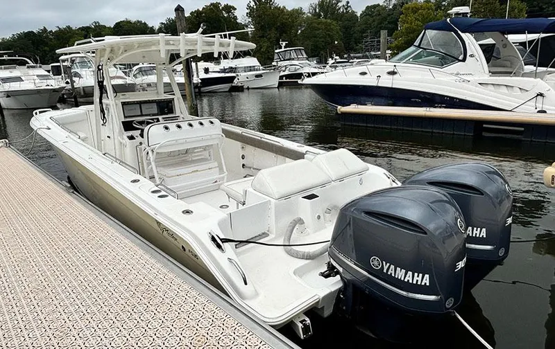 Slide: The Image of 2003 Marlago FS35 boat with twin Yamaha engines docked at a marina. - 4