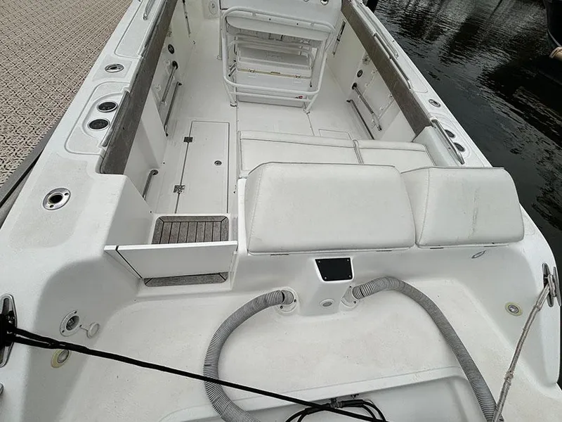 Slide: The Image of 2003 Marlago FS35 boat interior with white seating and storage compartments. - 6