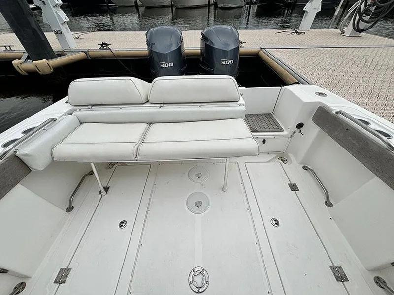 Slide: The Image of 2003 Marlago FS35 boat with dual 300 horsepower engines, docked at a marina. - 8