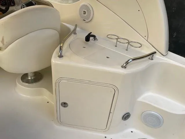 Slide: The Image of Interior of 2001 Sea Ray 280 Sundancer boat with seating and storage area. - 10