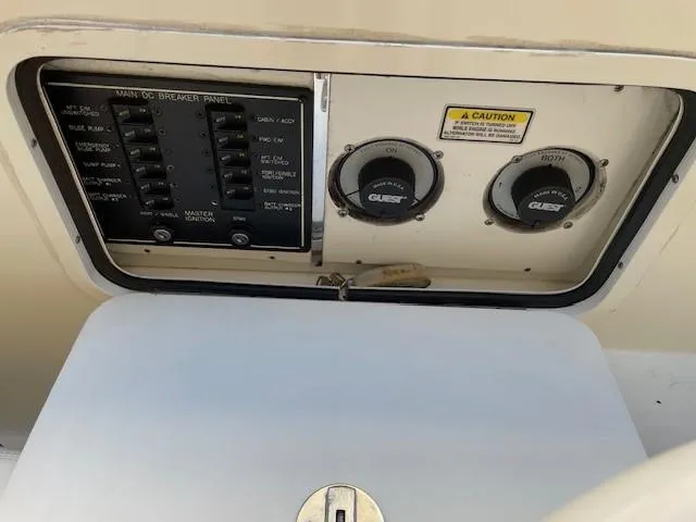 Slide: The Image of 2001 Sea Ray 280 Sundancer electrical panel with controls and caution label. - 11