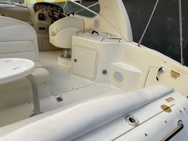 Slide: The Image of 2001 Sea Ray 280 Sundancer boat interior with seating and helm. - 12