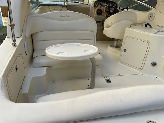 Slide: The Image of 2001 Sea Ray 280 Sundancer boat interior with seating and table. - 13