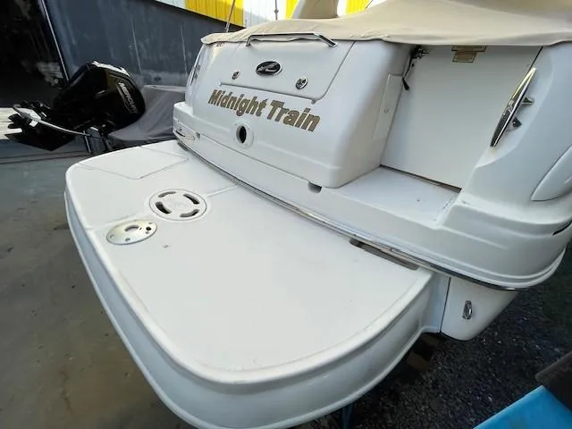 Slide: The Image of 2001 Sea Ray 280 Sundancer boat, rear view, docked, with "Midnight Train" name. - 15