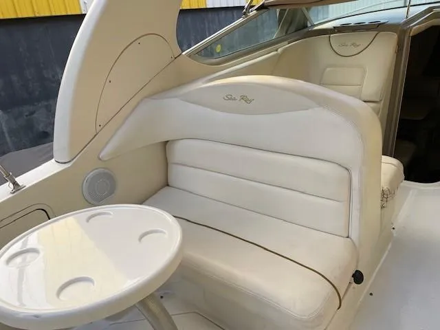 Slide: The Image of 2001 Sea Ray 280 Sundancer interior with white seating and round table. - 16