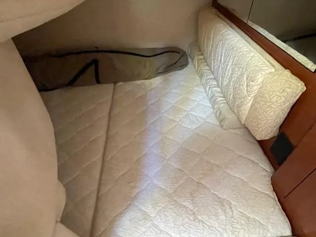 Slide: The Image of 2001 Sea Ray 280 Sundancer cabin interior with quilted bedding. - 19