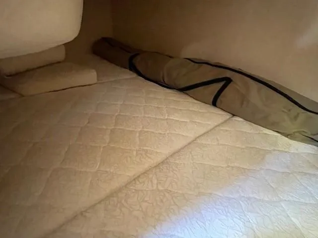 Slide: The Image of Interior cabin of 2001 Sea Ray 280 Sundancer with beige quilted bedding. - 20