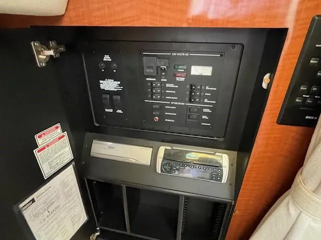 Slide: The Image of Electrical control panel in a 2001 Sea Ray 280 Sundancer boat interior. - 22
