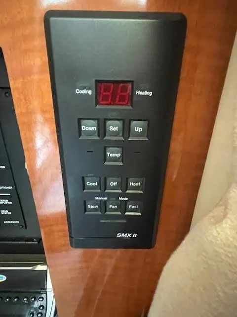 Slide: The Image of Control panel of a 2001 Sea Ray 280 Sundancer boat, featuring temperature settings. - 23