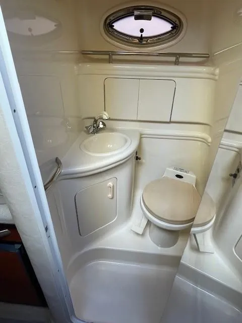 Slide: The Image of Compact bathroom in 2001 Sea Ray 280 Sundancer boat with sink and toilet. - 25
