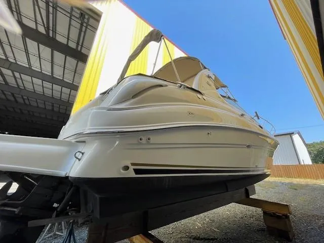 Slide: The Image of 2001 Sea Ray 280 Sundancer boat in storage, viewed from the stern. - 3