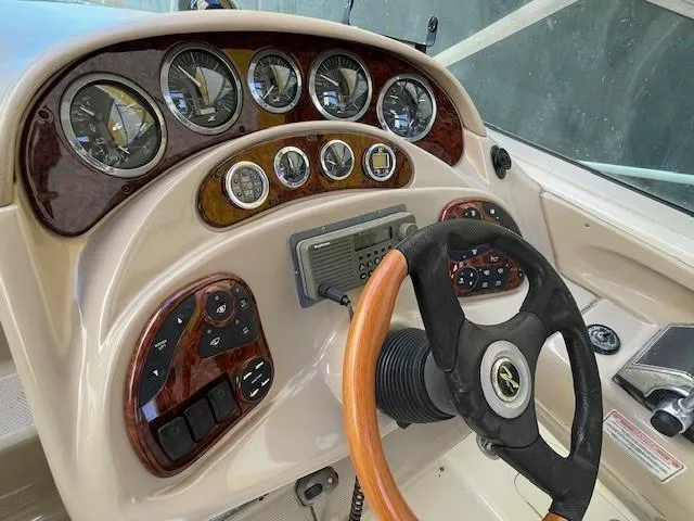Slide: The Image of 2001 Sea Ray 280 Sundancer dashboard with wood accents and steering wheel. - 33