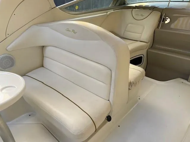Slide: The Image of Interior of 2001 Sea Ray 280 Sundancer boat with beige seating and sleek design. - 37