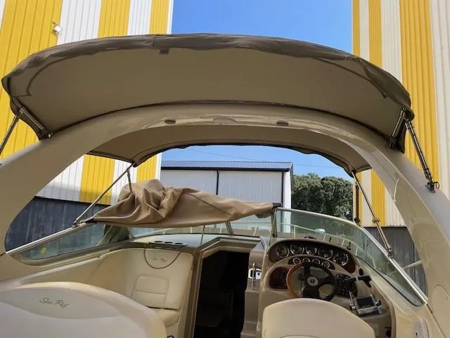 Slide: The Image of 2001 Sea Ray 280 Sundancer boat interior with canopy and dashboard. - 6